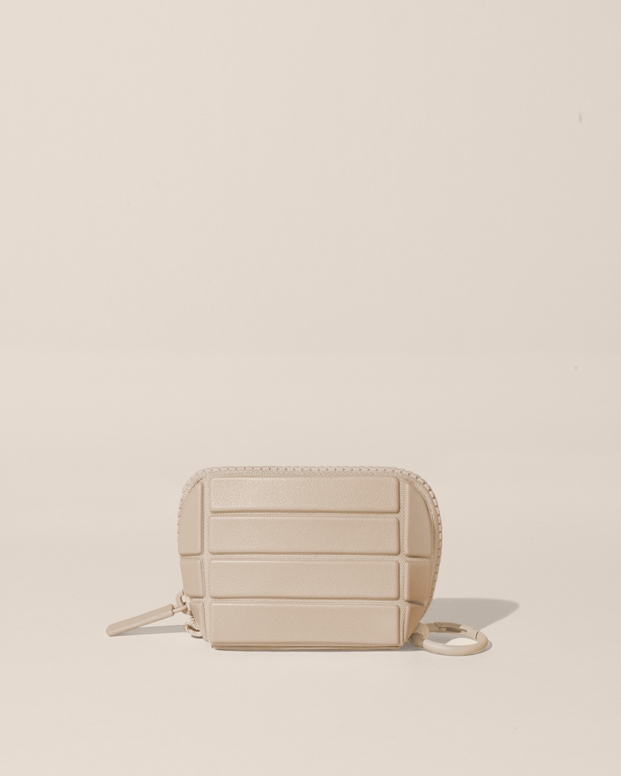 Closed Parallelle Bisque (white) Traveller Keychain with structured horizontal bar design shown from the front