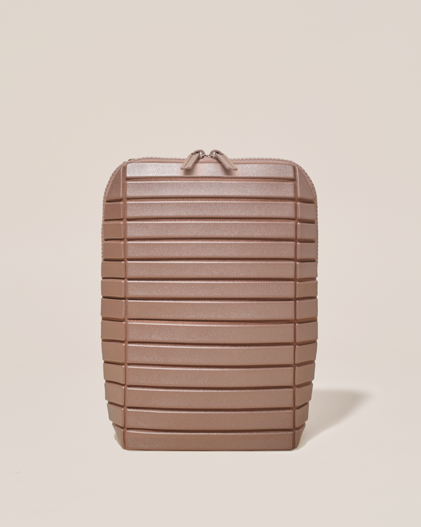 Closed Parallelle Bronze Brush Traveller makeup bag with structured horizontal bar design