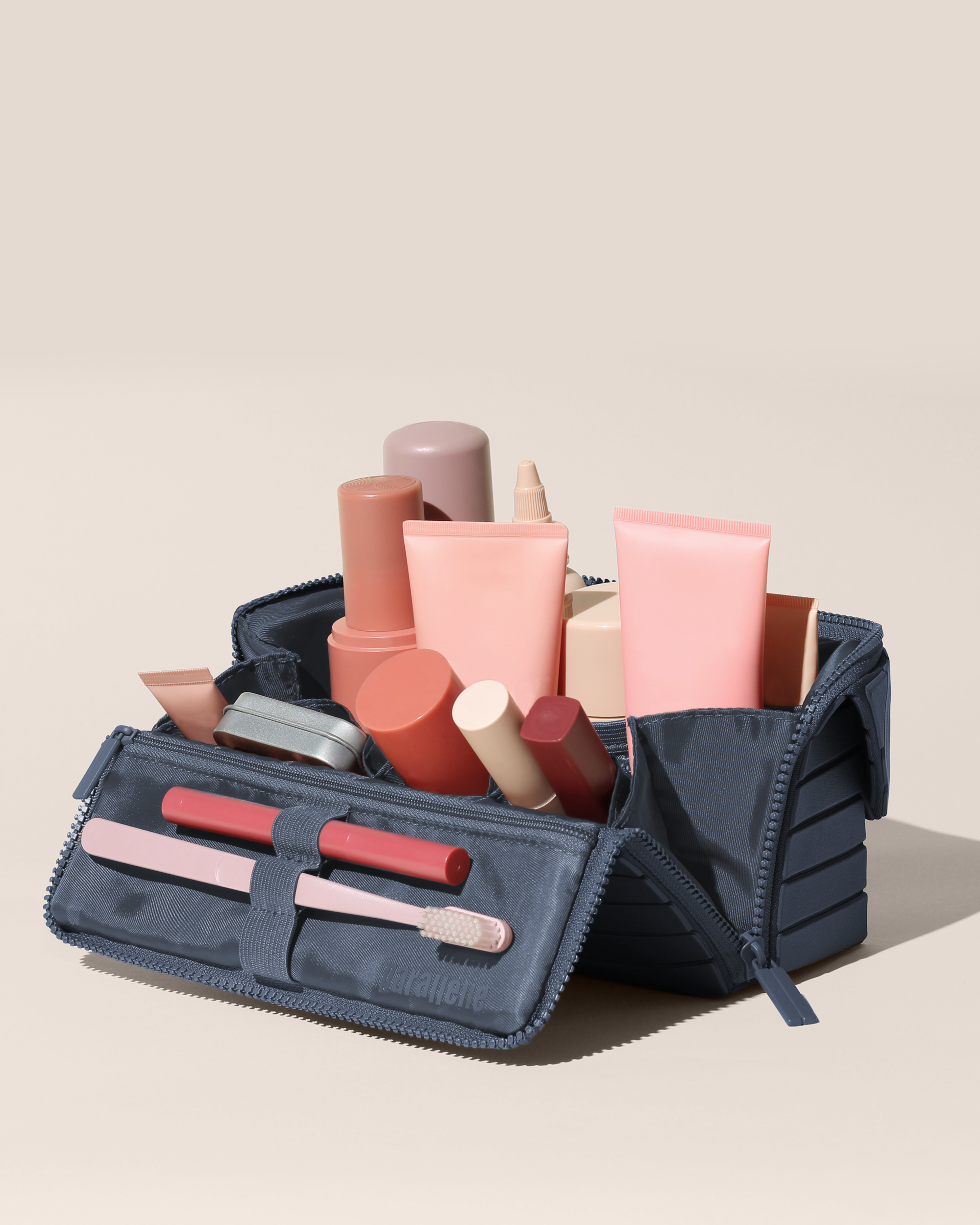 Open Parallelle Medum Indigo (blue) Kit, shown open and packed with skincare and grooming products and expanded using its accordion opening