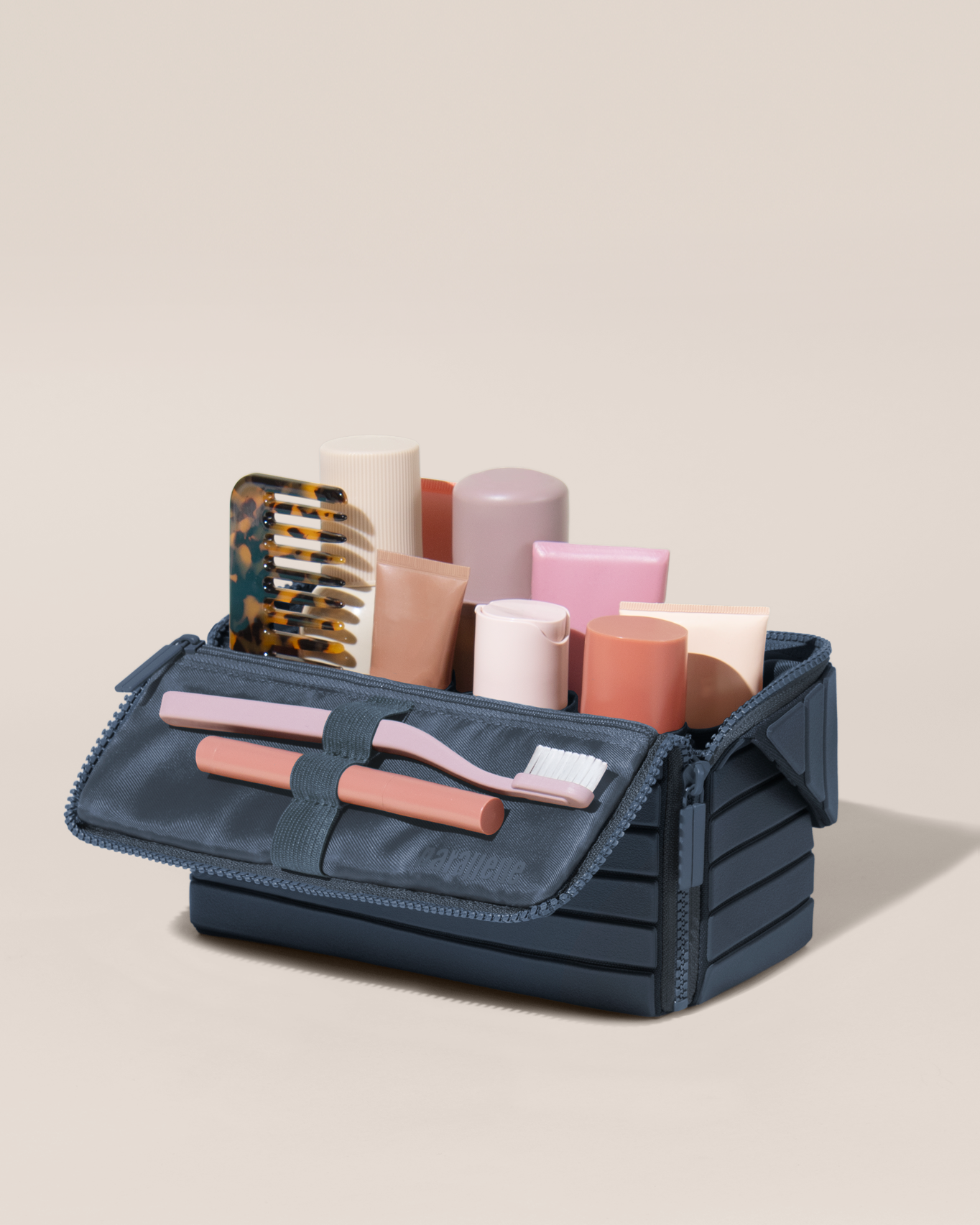 Open Parallelle Medum Indigo (blue) Kit, shown open and packed with skincare and grooming products. A compact, structured toiletry bag designed for visibility and access.