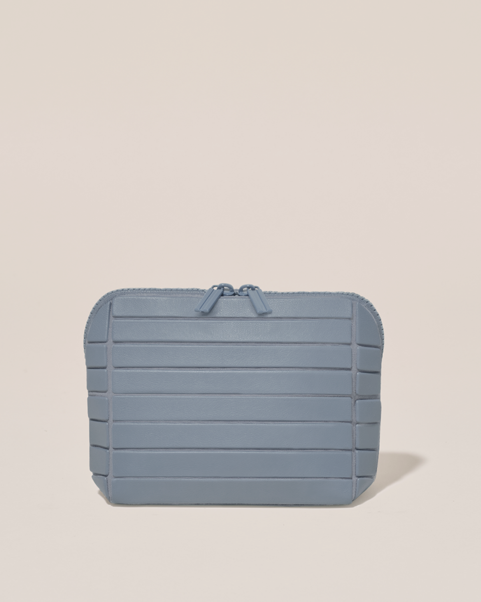 Closed Parallelle Small Slate (blue) Traveller makeup bag with structured horizontal bar design